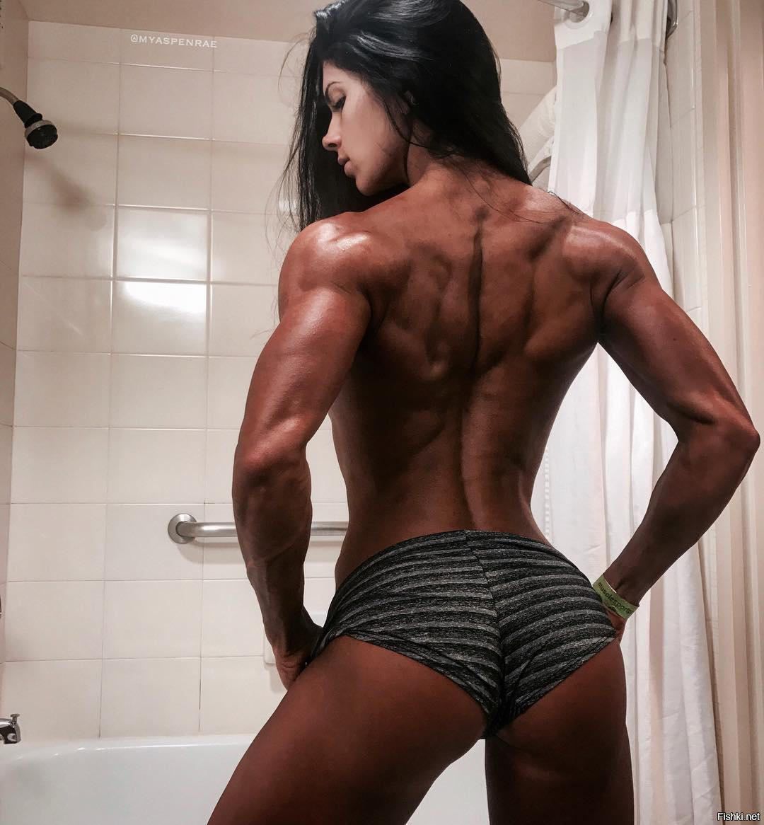 Muscular girl taking shower