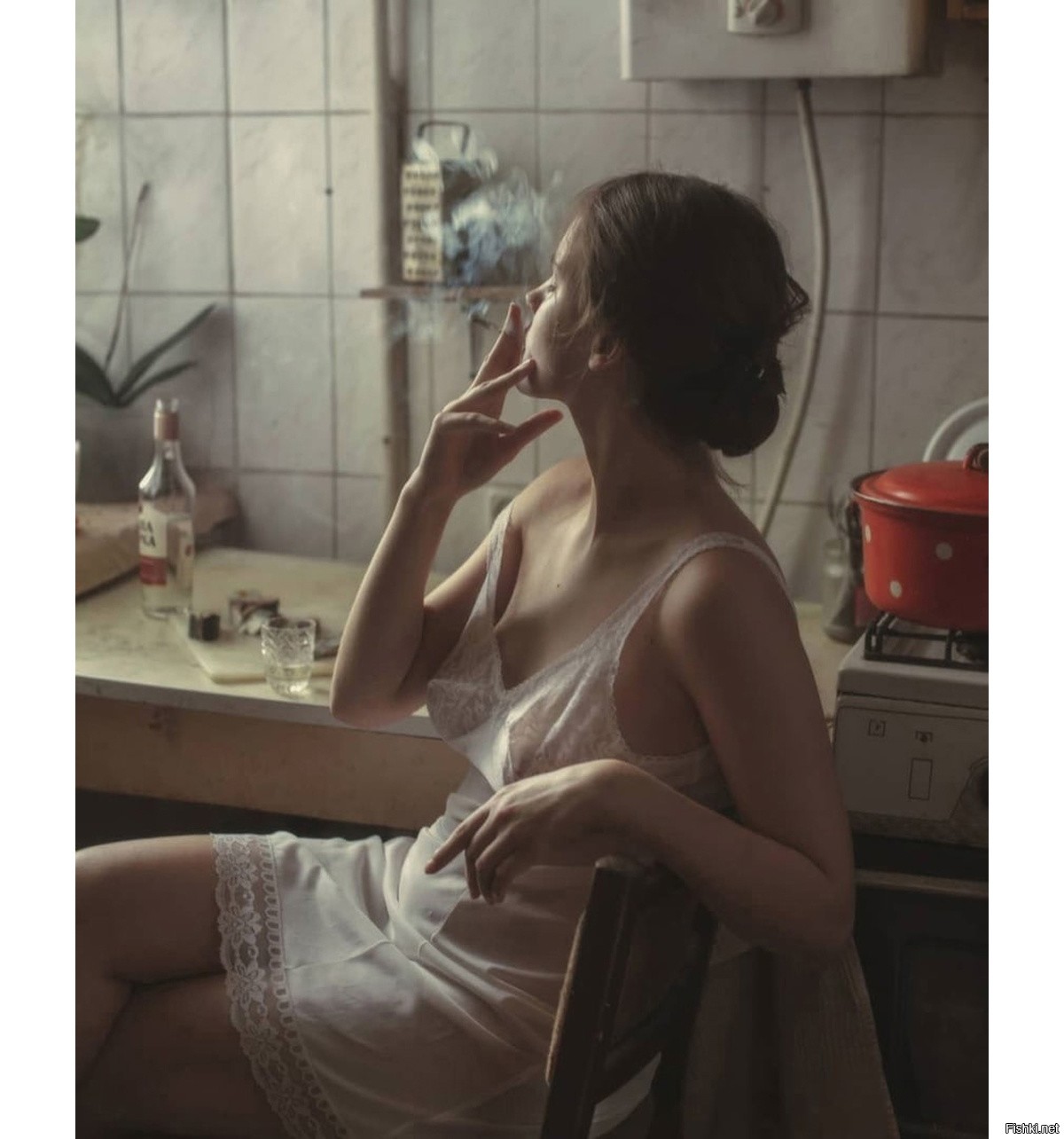 Девушка курит на кухне голая